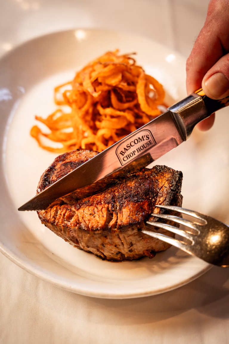 USDA Prime bone-in ribeye steak with branded steak knife at Bascom's Chop House in Clearwater, FL