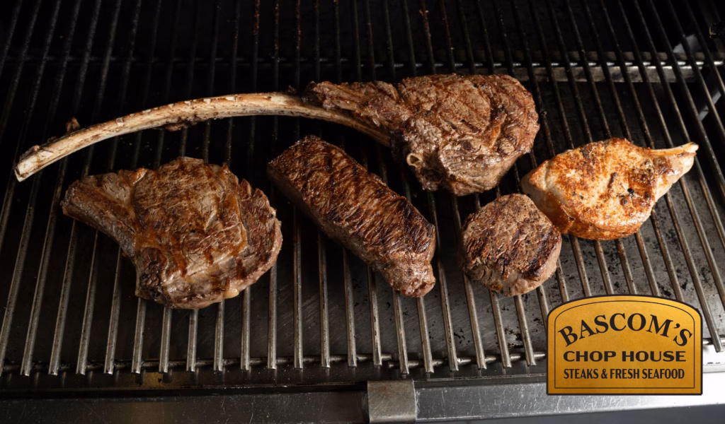Assortment of premium steaks cooking on the grill at Bascom’s Chop House in Clearwater